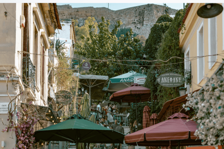 Bustling restaurant lined street in Plaka beneath the Acropolis, a neighborhood to explore on an Athens 2 day itinerary.
