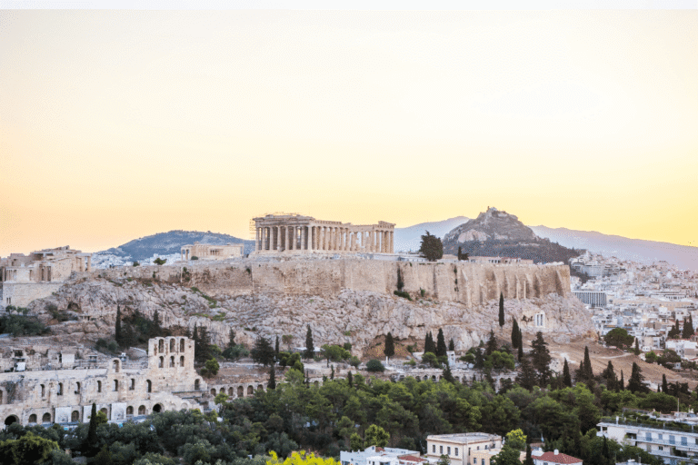 A sunset view of the Acropolis and Parthenon in Athens, Greece for Athens captions.