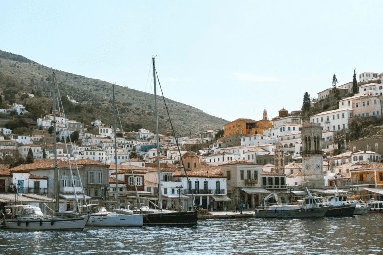 Hydra harbor lined with sailboats and traditional whitewashed houses, a scenic arrival on an Athens to Hydra day trip.