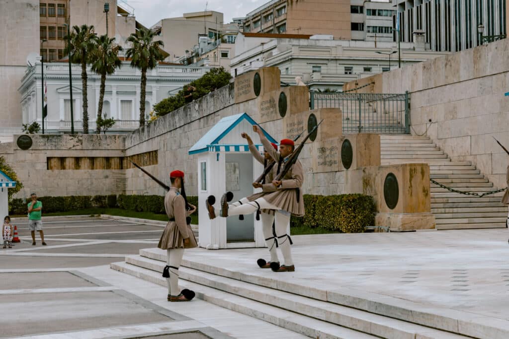 Evzones soldiers performing the ceremonial changing of the guard in front of the Hellenic Parliament in Syntagma Square, a free cultural experience in Athens.