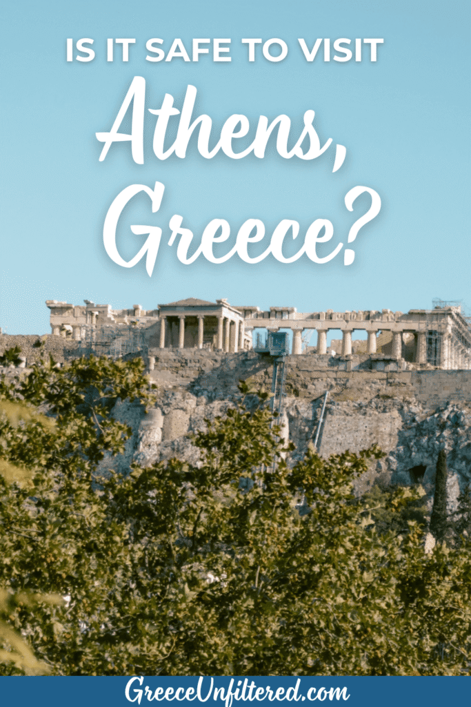 Pinterest pin with the text “Is it Safe to Visit Athens, Greece?” over a scenic view of the Acropolis ruins above green trees and a clear blue sky, highlighting a blog post about safety tips for visiting Athens, Greece.
