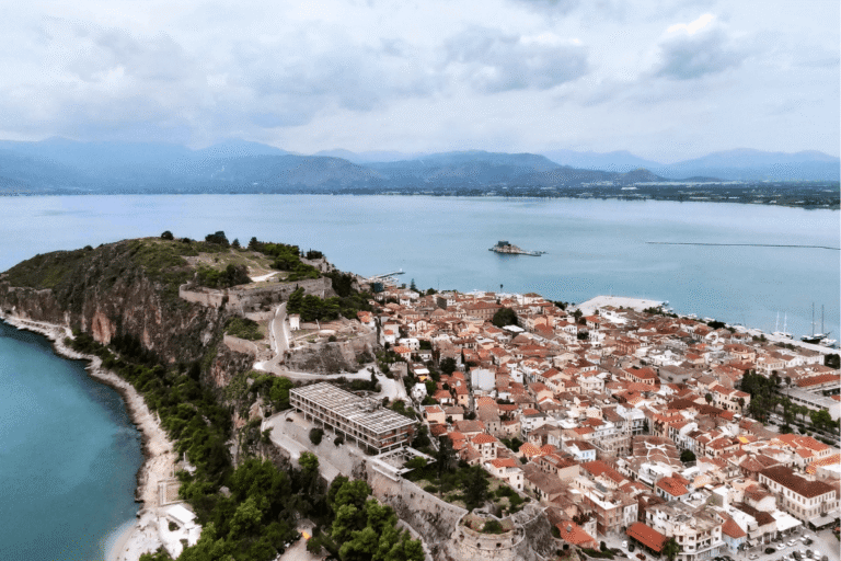 Aerial view of Nafplio Old Town and the Argolic Gulf with red tiled rooftops and Akronafplia fortress, showing what to do in Nafplio, Greece.