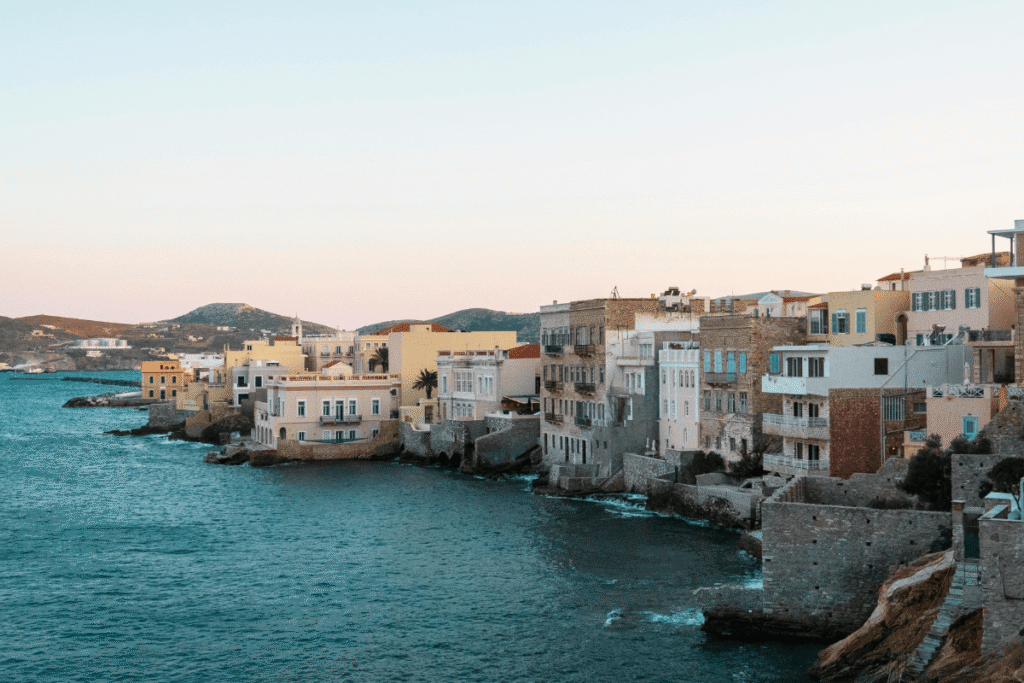 Colorful neoclassical buildings lining the waterfront in Ermoupoli, showcasing the distinctive architecture to see when deciding what to do in Syros.