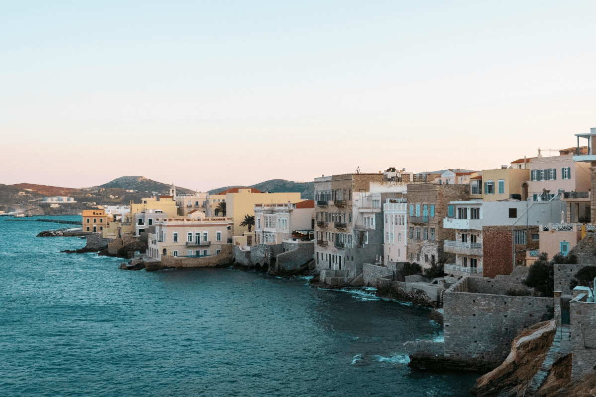 Colorful neoclassical buildings lining the waterfront in Ermoupoli, showcasing the distinctive architecture to see when deciding what to do in Syros.