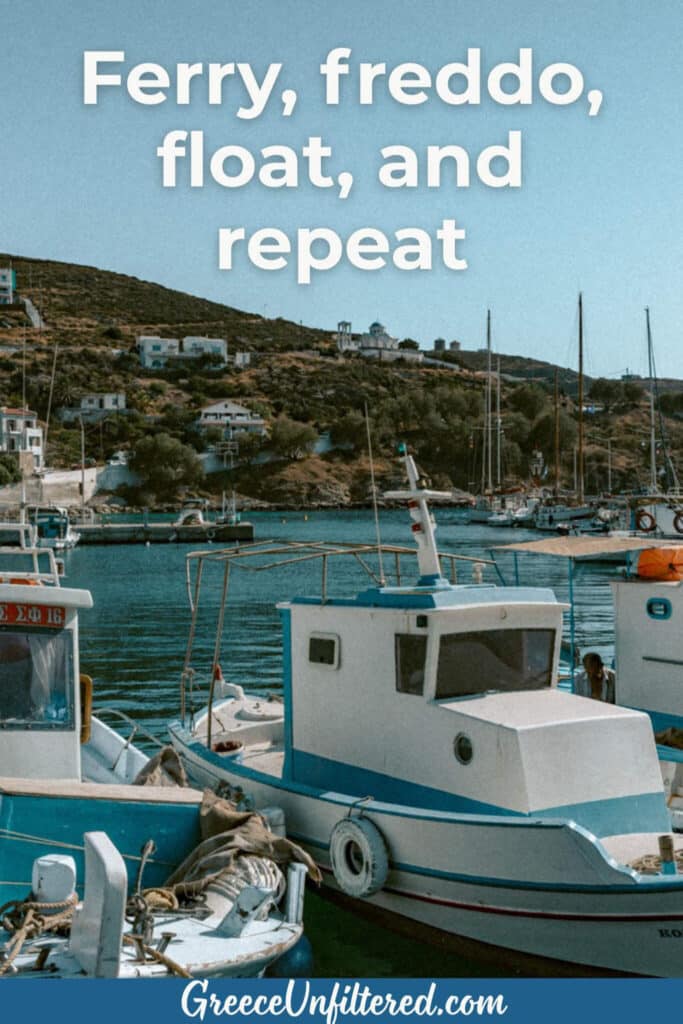 Colorful fishing boats float in a peaceful Greek island harbor, surrounded by classic white homes and blue domes, and the text “Ferry, freddo, float, and repeat.”