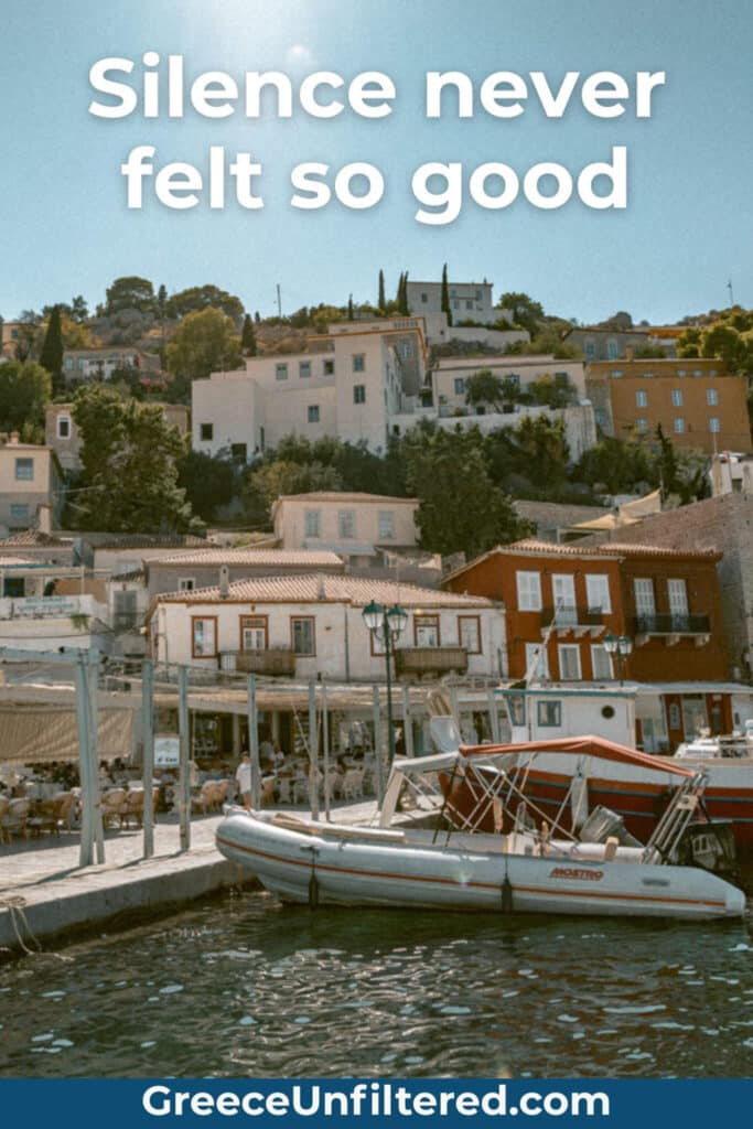 A sun-soaked Greek island harbor with outdoor cafés, boats, and hillside homes under a clear sky, overlaid with “Silence never felt so good.” A quiet moment that would work for quotes on Greek island tranquility.