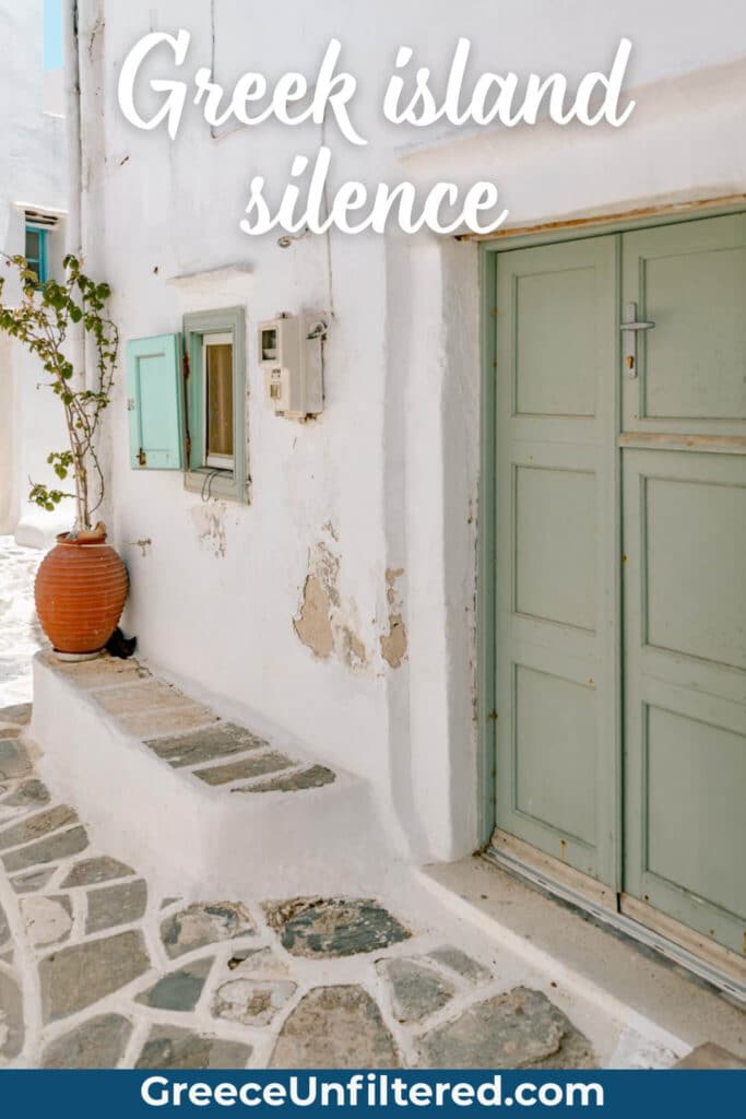 A peaceful Greek island alleyway with a terracotta pot and mint green door, text reads “Greek island silence.” This captures the calm, slow-paced life found in many Greek island quotes.