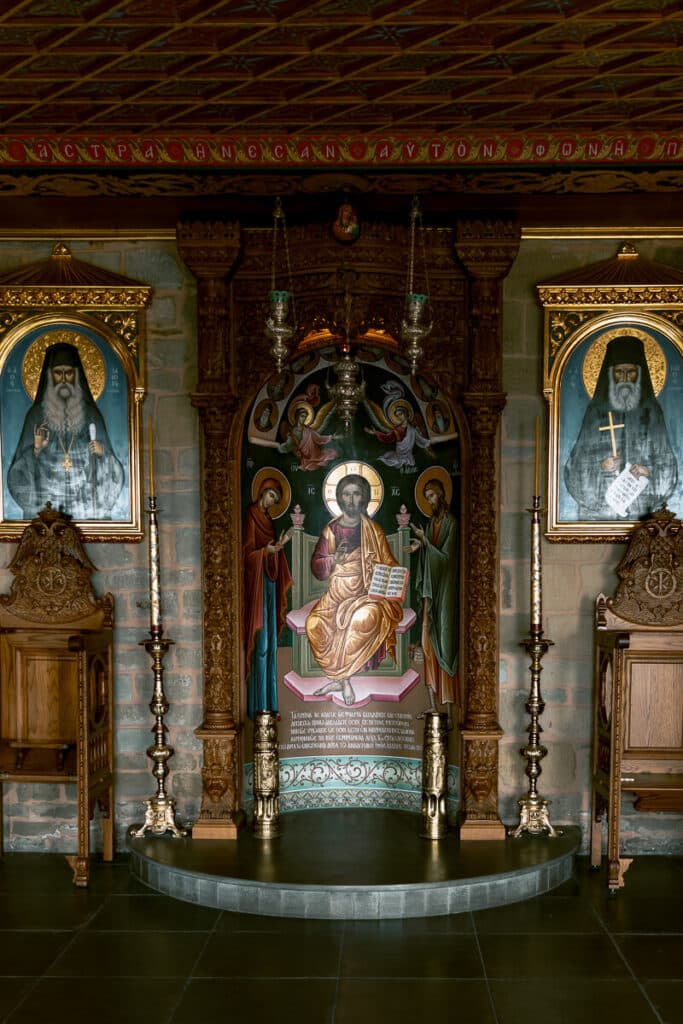 Colorful iconostasis and detailed religious paintings inside a Meteora monastery, capturing the spiritual and artistic side of Greek Orthodox tradition.