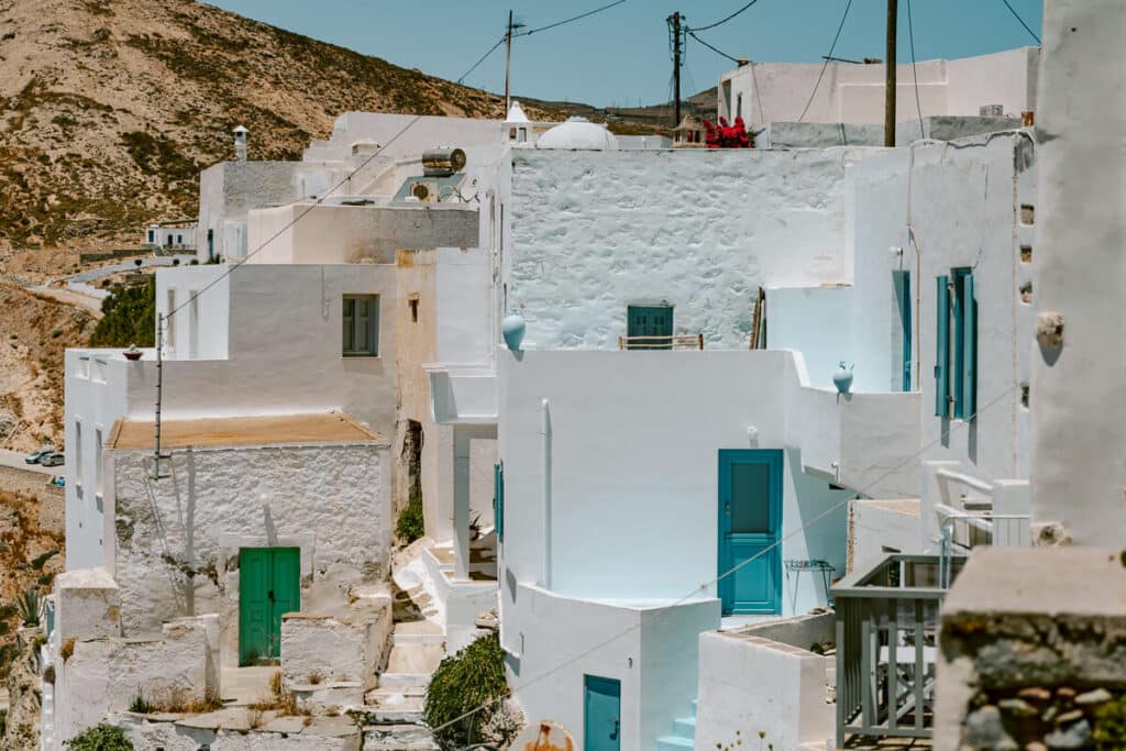 Another view of Serifos Chora’s hillside houses with blue doors and domed rooftops glowing under the summer sun.