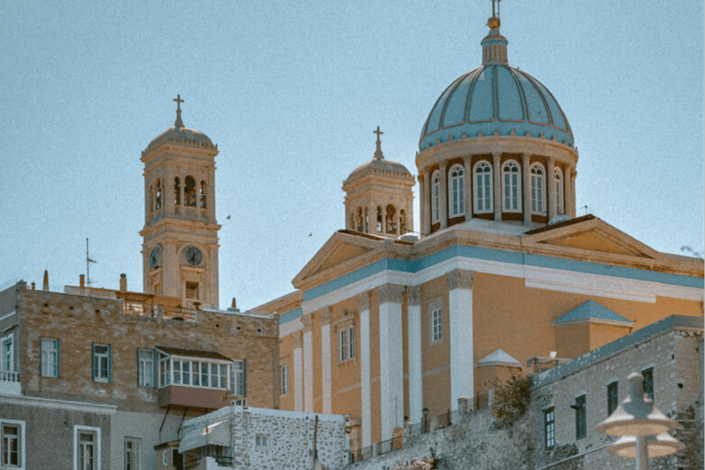 Syros Greece, one of the best Greek islands for solo female travel, with a blue-domed church in Ermoupoli.