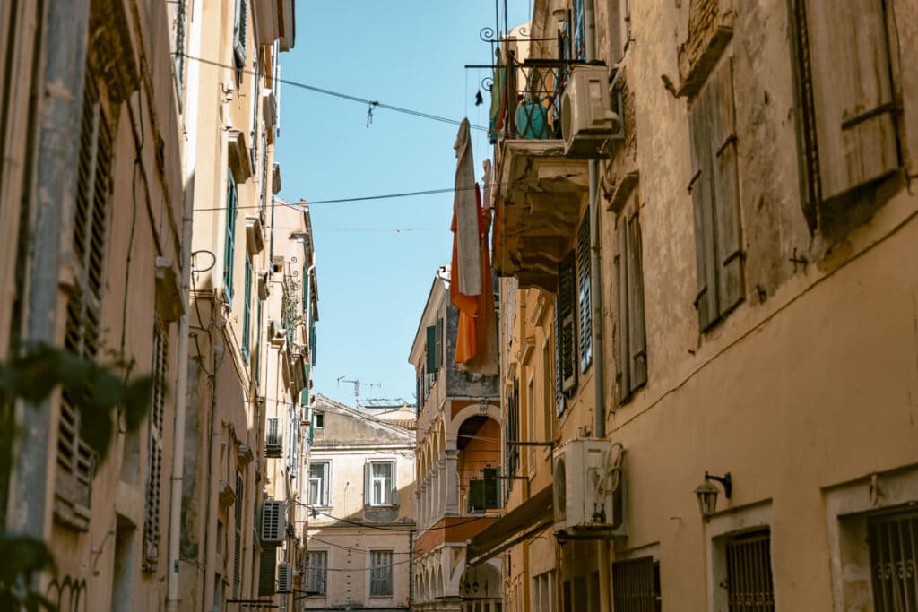 Narrow street with old buildings in Corfu Old Town, Greece.