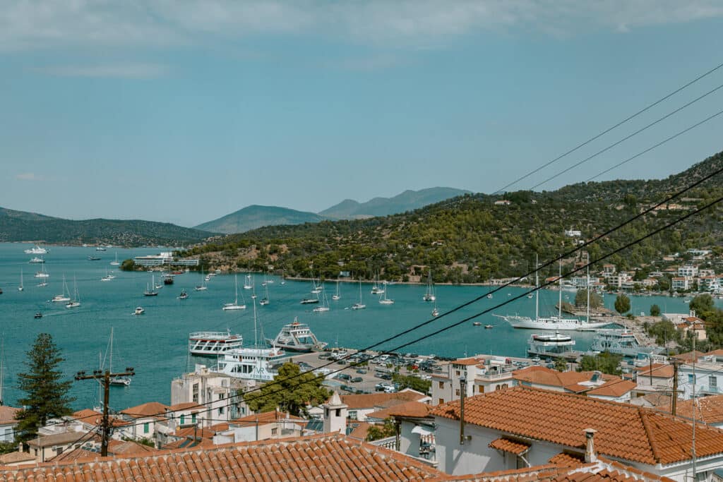 Elevated view of Poros island and harbor full of sailboats, showing why Greece is safe for female solo travel.