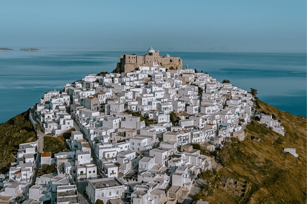 Astypalaia Greece, a quiet Greek island for solo female travel, with whitewashed houses and a hilltop castle overlooking the sea.