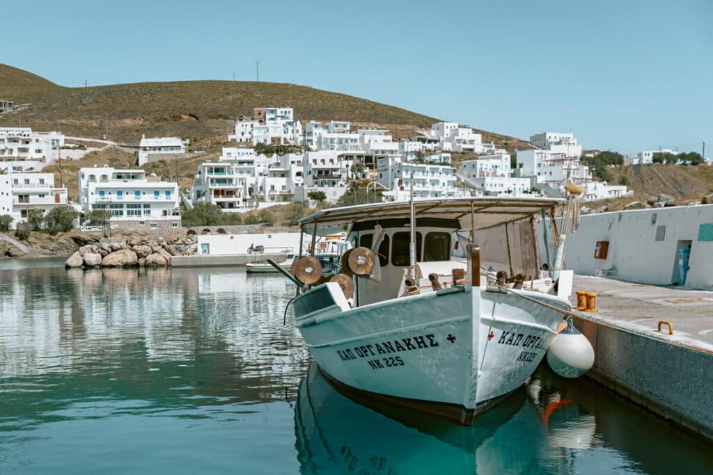 Traditional boat floating in crystal-clear water near Livadi — one of the laid-back local moments to enjoy when planning what to do in Astypalaia.