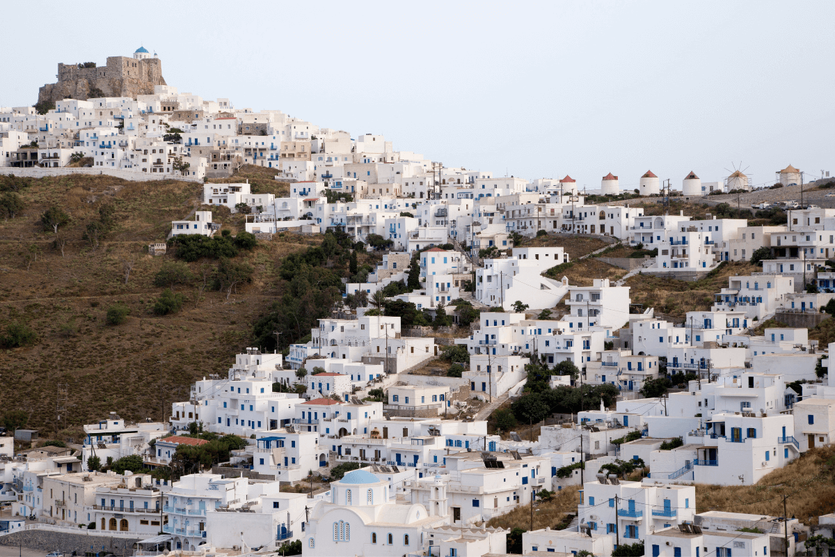 View of Chora on Astypalaia island with traditional white houses, windmills, and the Venetian castle, a must-see when planning what to do in Astypalaia.
