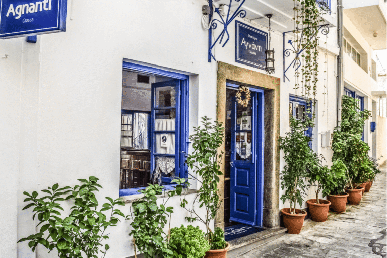Traditional Greek taverna with blue doors and potted plants, a charming stop to include in a 1 week in Greece itinerary.