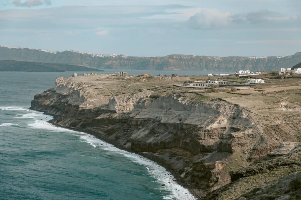 Dramatic cliffside coastline of Santorini’s south side with waves crashing in winter