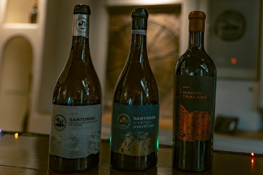 Three bottles of Santorini wine on display at Koutsoyannopoulos Wine Museum
