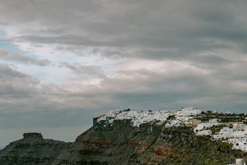 Santorini cliffside village under moody winter skies