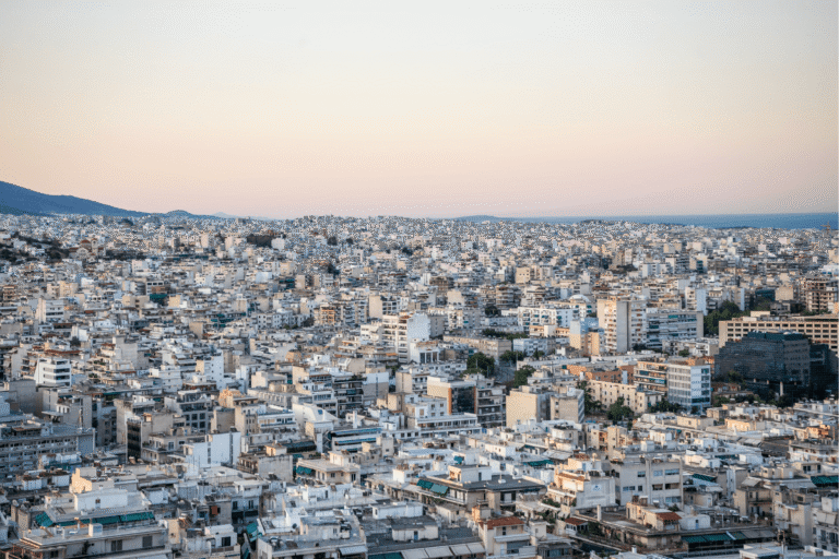 Panoramic view of Athens, Greece, at sunset overlooking the city, a stop featured in this 5 day Greece itinerary.