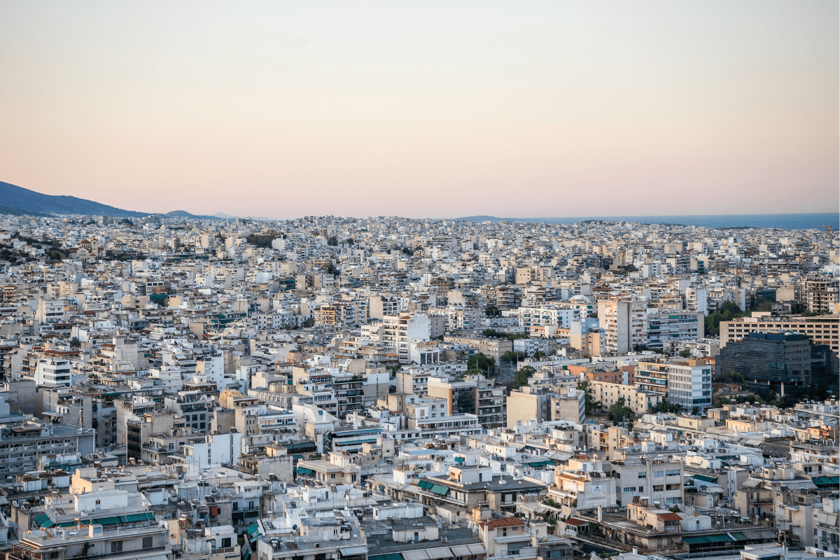 Panoramic view of Athens, Greece, at sunset overlooking the city, a stop featured in this 5 day Greece itinerary.