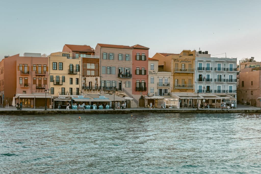 Colorful waterfront buildings and restaurants along the harbor in Chania, Crete, one of the best Greek islands to visit for the first time