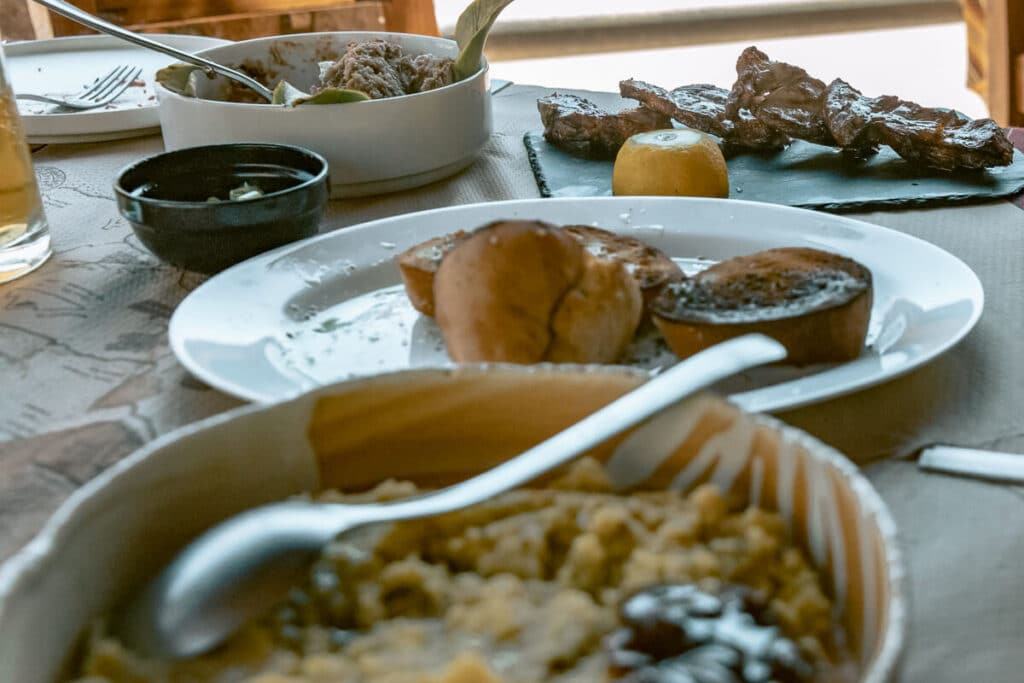 Traditional Cretan dishes and grilled meat served on a table at a village restaurant near Chania