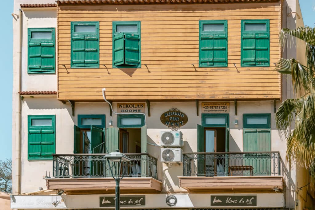 Building with green shutters and balconies in Chania, showing the mix of historic architecture and local guesthouses in Old Town