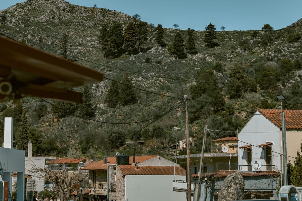 Stone building and outdoor seating at a rustic restaurant in Theriso village during a day trip from Chania