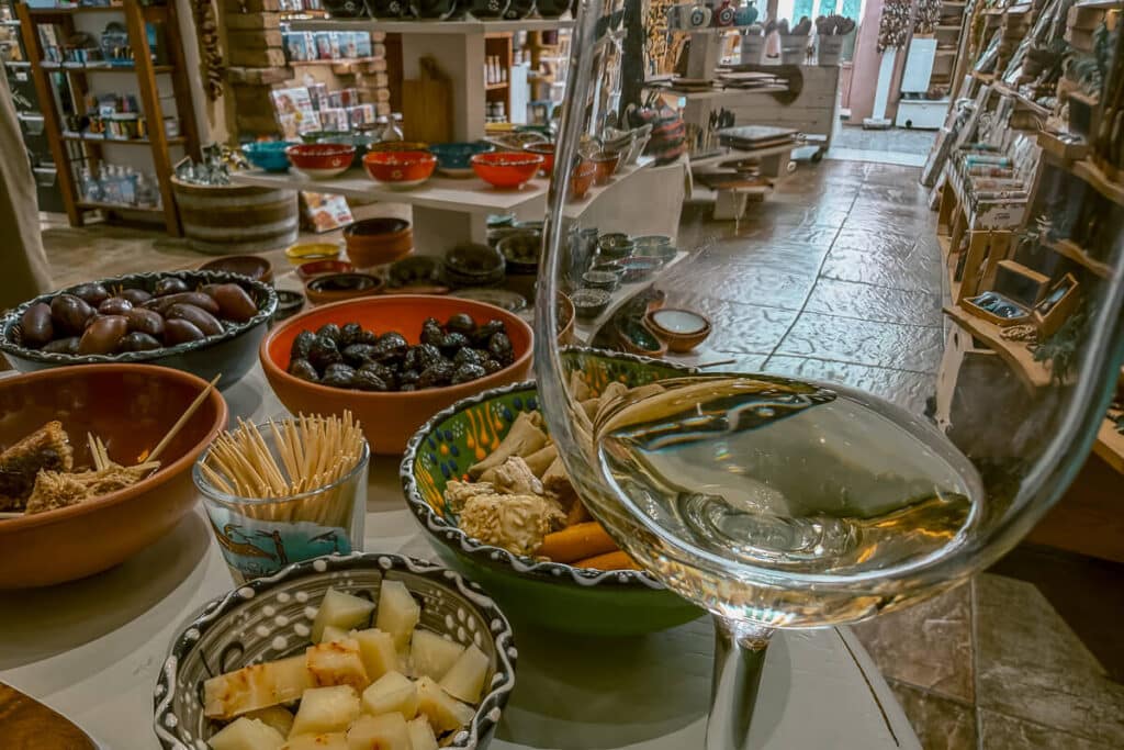 Wine tasting setup in Chania with local cheese, olives, and an empty glass ready for Cretan wines