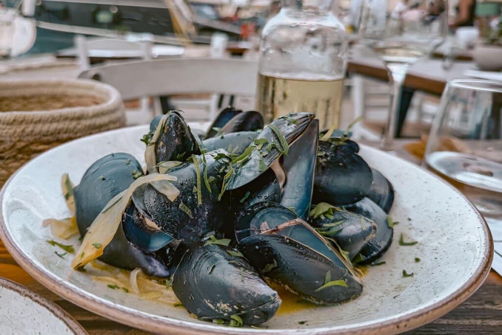Plate of mussels with herbs and sauce served at an outdoor restaurant in Paxos.