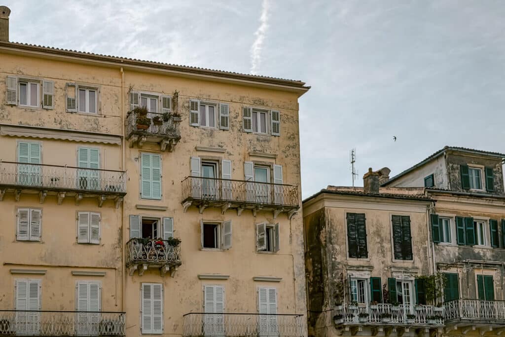 Pastel buildings with shutters and balconies near Liston in Corfu Old Town.