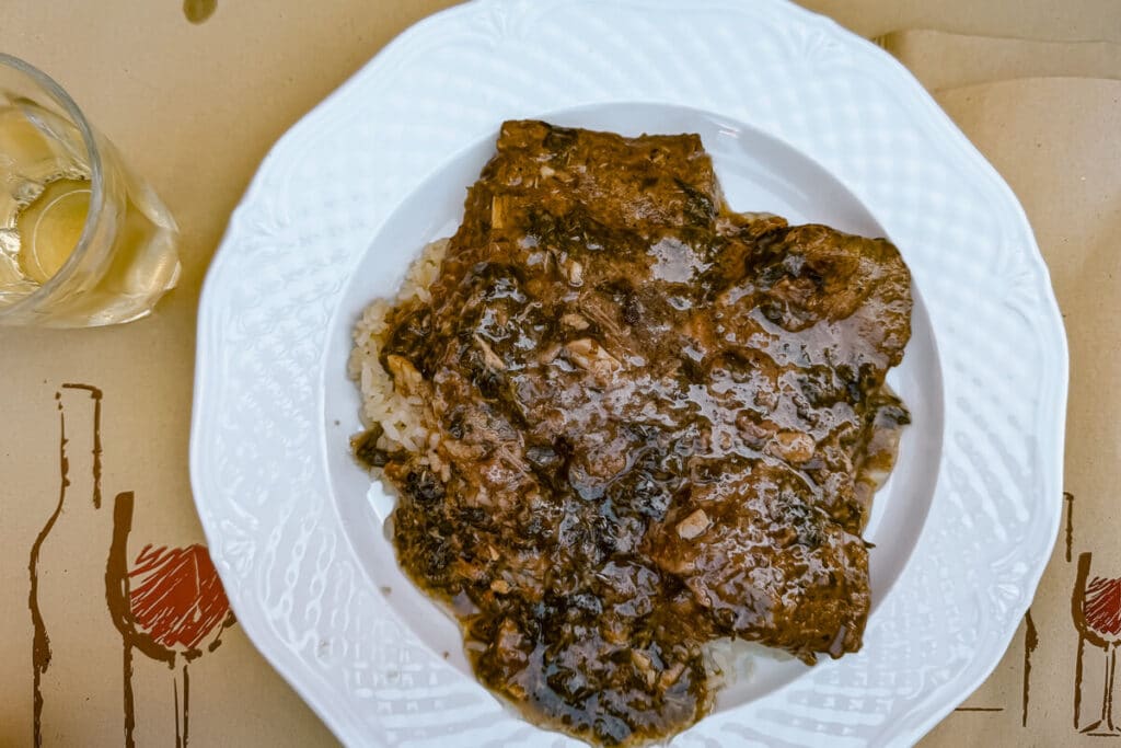 Sofrito with rice in a garlicky sauce served on a white plate at Stou Maka in Corfu Old Town.
