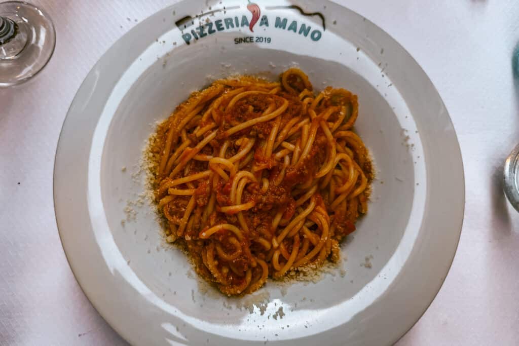 Spaghetti with tomato sauce and grated cheese served at Pizzeria A Mano in Corfu Old Town.